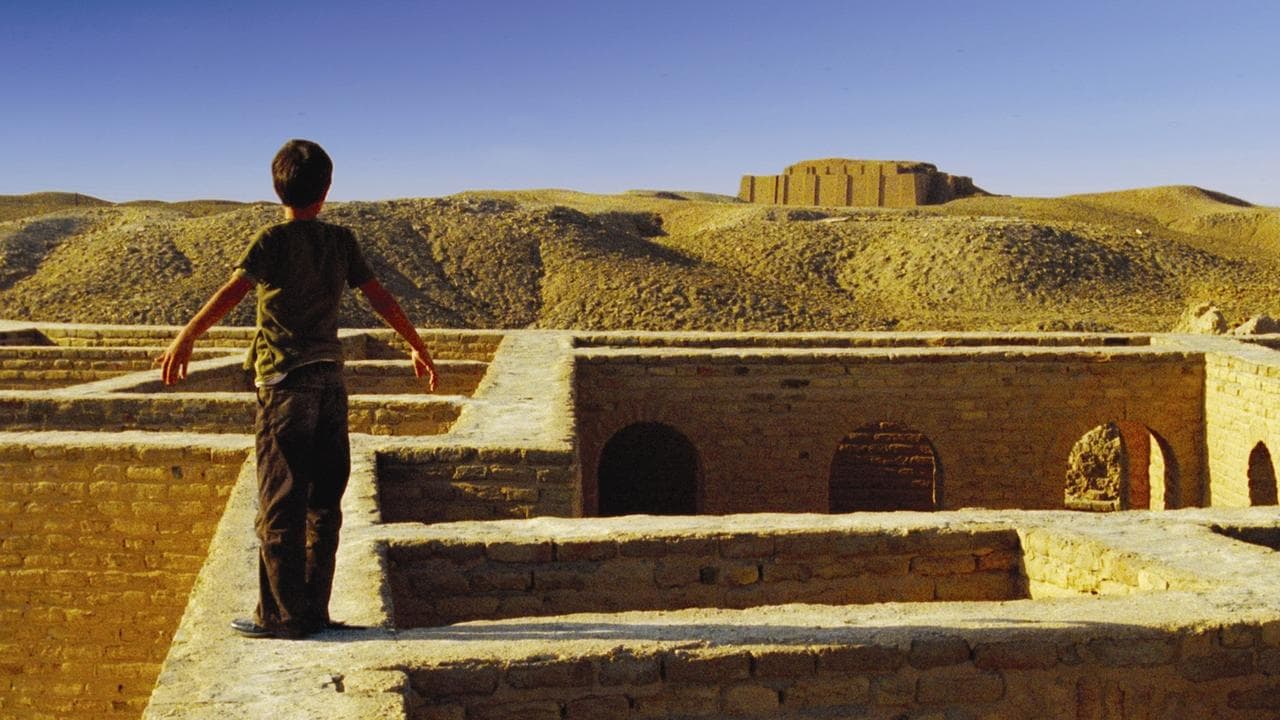 A boy stands before the ancient ruins of Ur, from the film Ahlaam